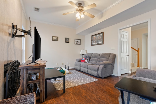 living room featuring ornamental molding, ceiling fan, and dark hardwood / wood-style flooring