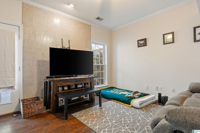 living room featuring crown molding and hardwood / wood-style flooring