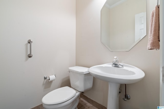 bathroom with crown molding and toilet