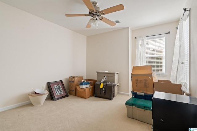 misc room with ceiling fan and light carpet