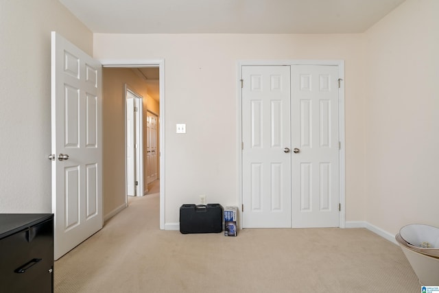 bedroom featuring light colored carpet and a closet