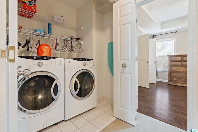 laundry room with tile patterned flooring, washing machine and dryer, and ornamental molding