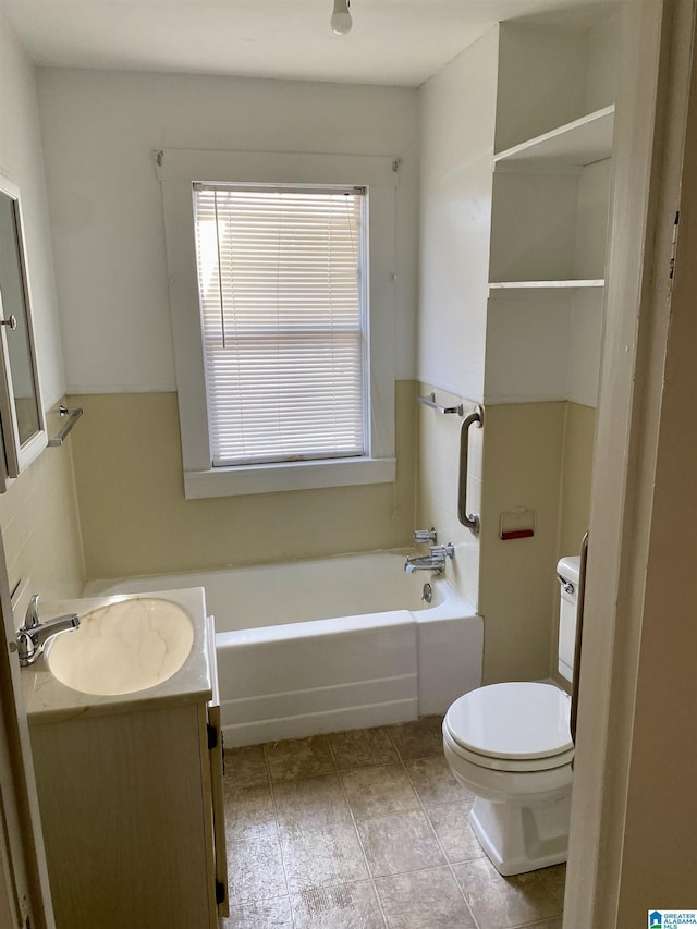 bathroom with tile patterned flooring, vanity, a washtub, and toilet