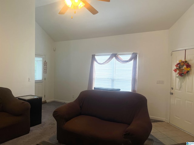 living room featuring lofted ceiling, light tile patterned floors, and ceiling fan