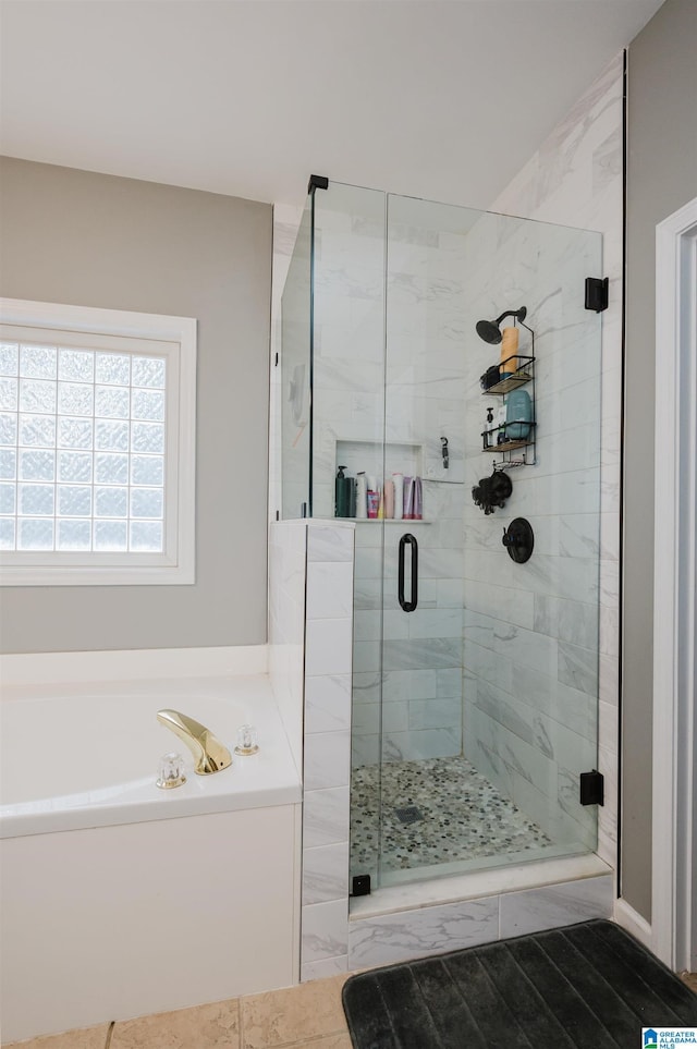 bathroom with hardwood / wood-style floors and shower with separate bathtub