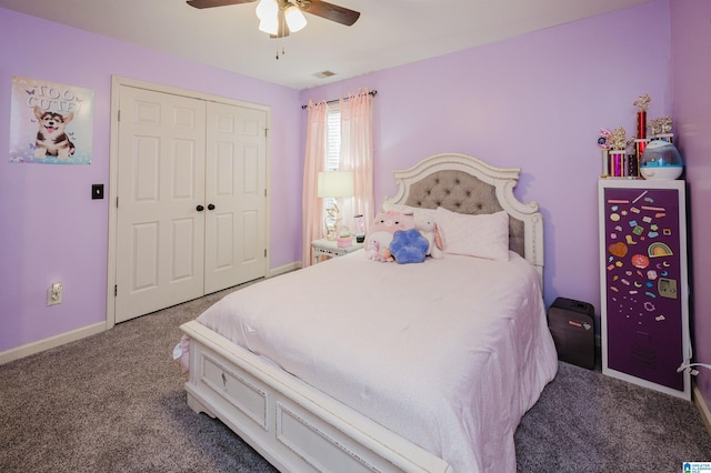 bedroom with ceiling fan, dark carpet, and a closet