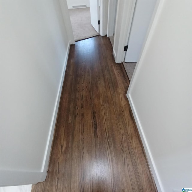 corridor featuring dark hardwood / wood-style floors