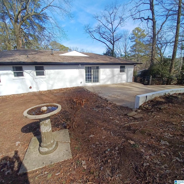 back of property with a patio