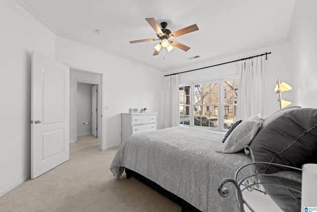 carpeted bedroom with ornamental molding and ceiling fan