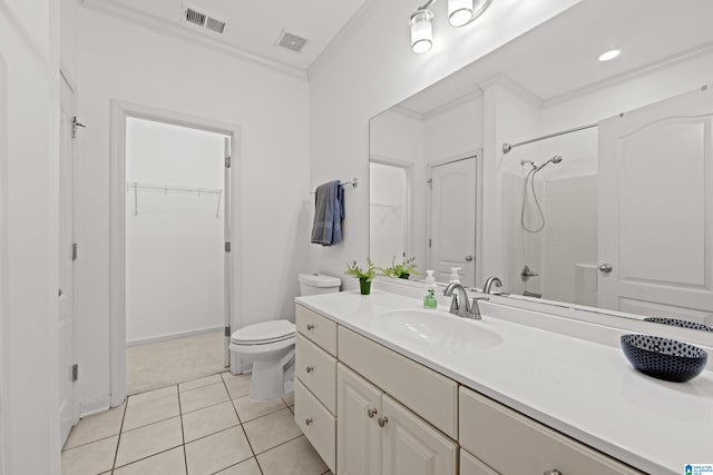 bathroom with tile patterned floors, toilet, vanity, and a shower