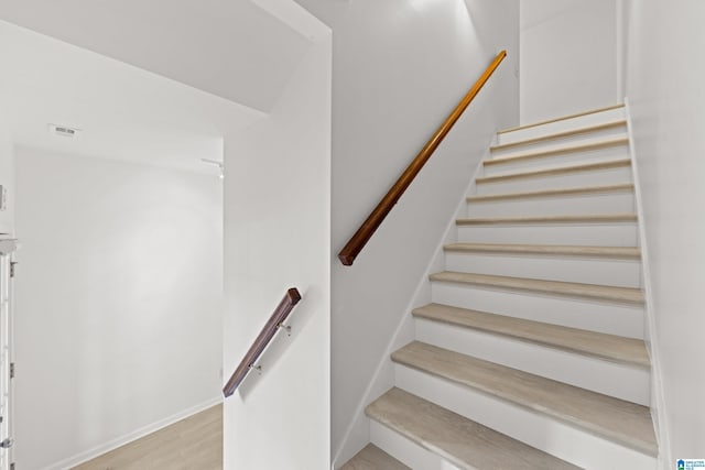 stairway with wood-type flooring