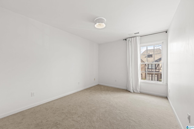 spare room with light colored carpet