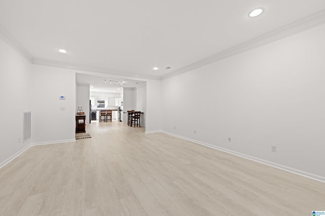 unfurnished room with crown molding and light wood-type flooring