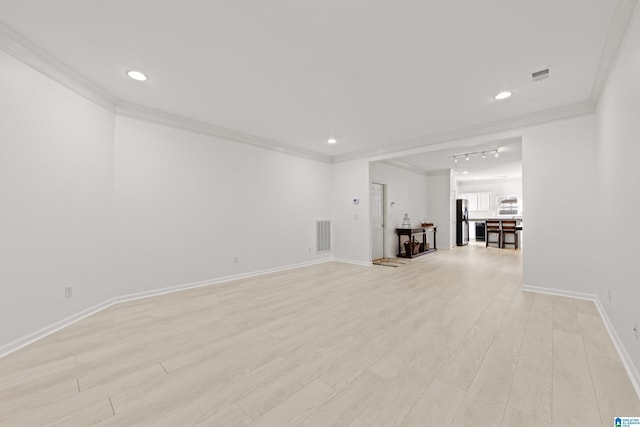 unfurnished room featuring crown molding and light hardwood / wood-style floors