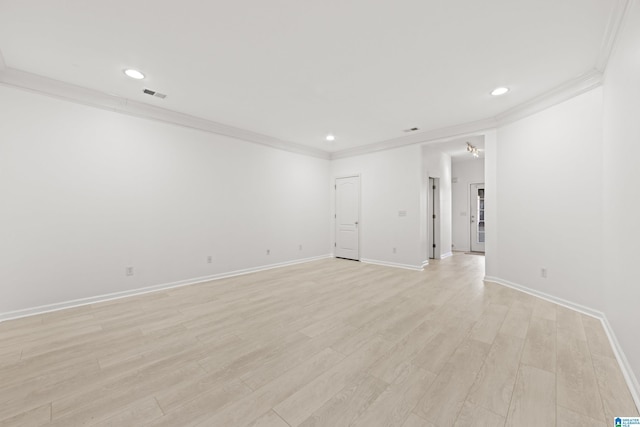 spare room with crown molding and light hardwood / wood-style flooring