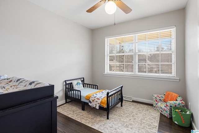 bedroom featuring ceiling fan and dark hardwood / wood-style flooring