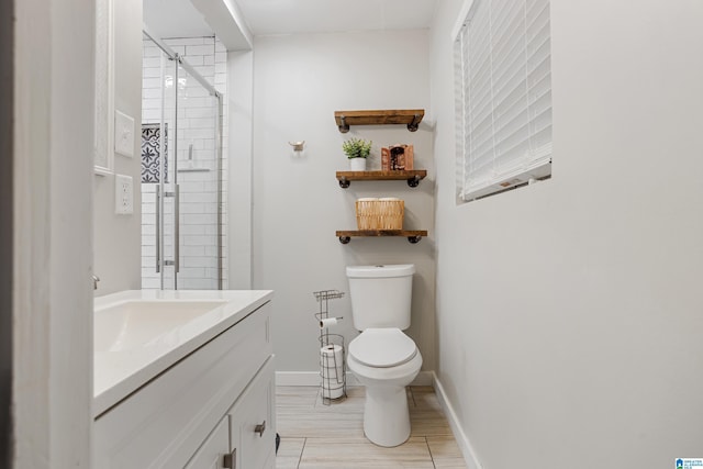 bathroom with vanity, an enclosed shower, and toilet