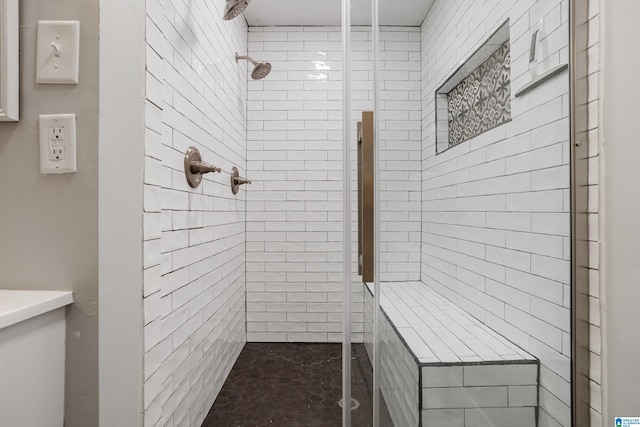 bathroom featuring a shower with door