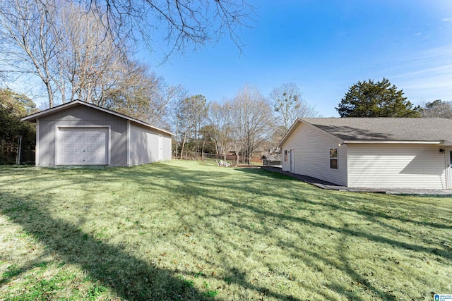 view of yard featuring a garage and an outdoor structure