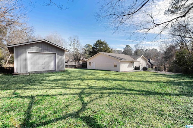 view of yard featuring an outbuilding and a garage