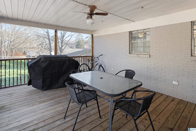 wooden terrace with area for grilling and ceiling fan