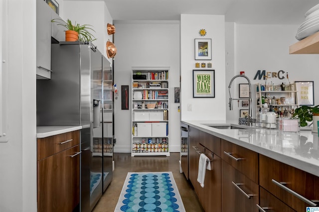 kitchen featuring stainless steel refrigerator with ice dispenser and sink