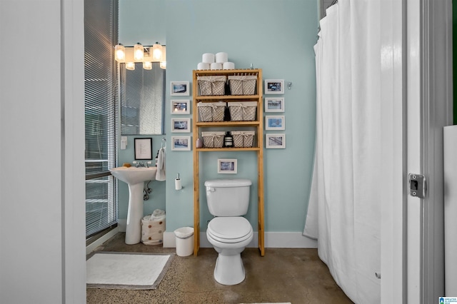 bathroom featuring toilet and a shower with shower curtain