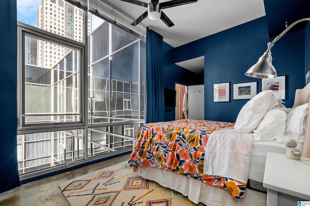 bedroom featuring ceiling fan and concrete flooring