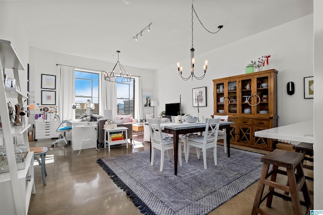 dining area with a notable chandelier and rail lighting