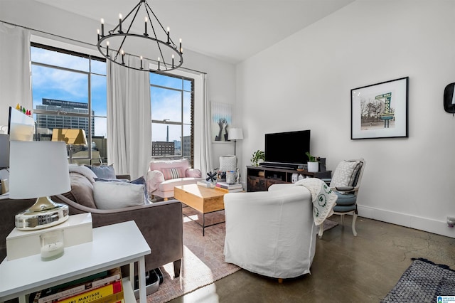 living room with concrete floors and a chandelier