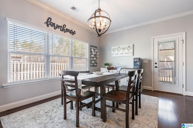 dining area featuring crown molding, dark hardwood / wood-style floors, and a notable chandelier