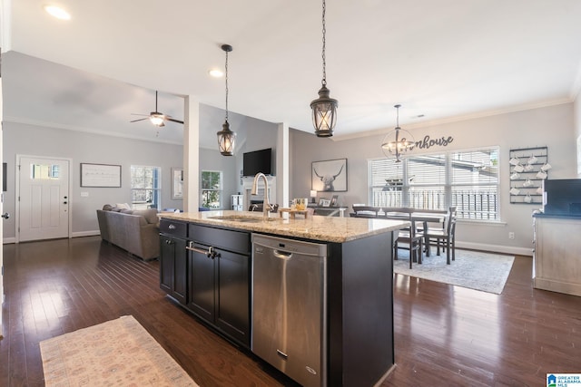 kitchen featuring sink, dishwasher, pendant lighting, light stone countertops, and a kitchen island with sink