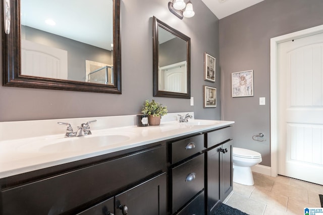 bathroom featuring tile patterned floors, vanity, and toilet