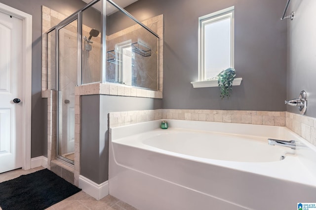 bathroom featuring tile patterned floors and separate shower and tub