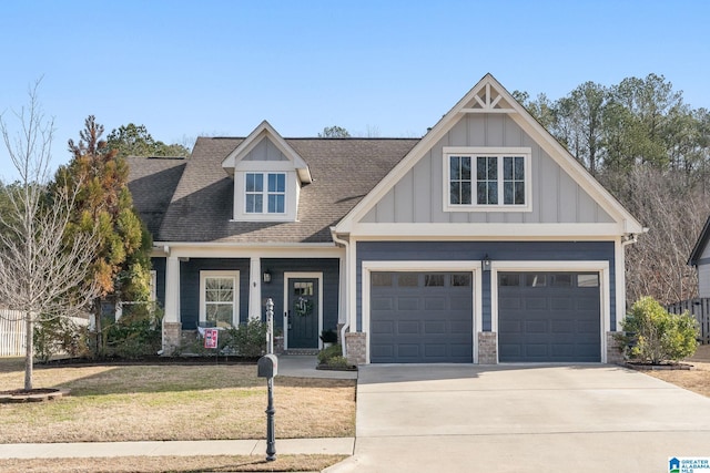 craftsman house featuring a garage and a front yard