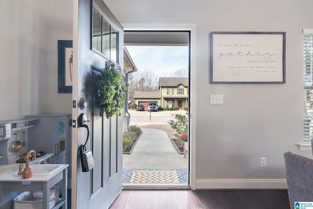 foyer entrance with hardwood / wood-style flooring and sink