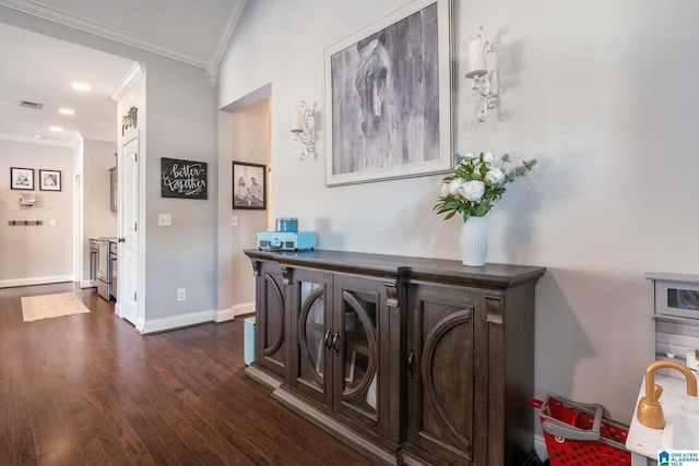 hallway featuring ornamental molding and dark hardwood / wood-style floors