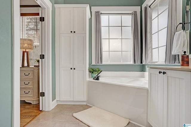 bathroom with tile patterned floors and a bathtub