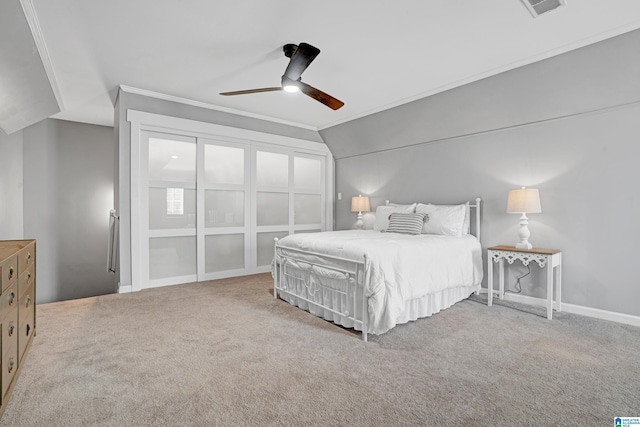 bedroom with vaulted ceiling, ornamental molding, ceiling fan, and carpet