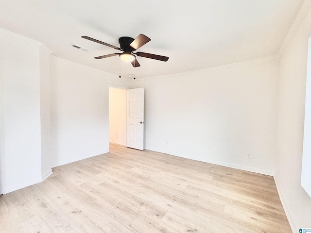 spare room featuring ceiling fan, ornamental molding, and light hardwood / wood-style floors