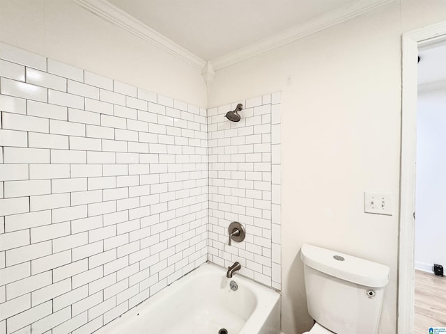 bathroom with hardwood / wood-style floors, crown molding, toilet, and tiled shower / bath combo