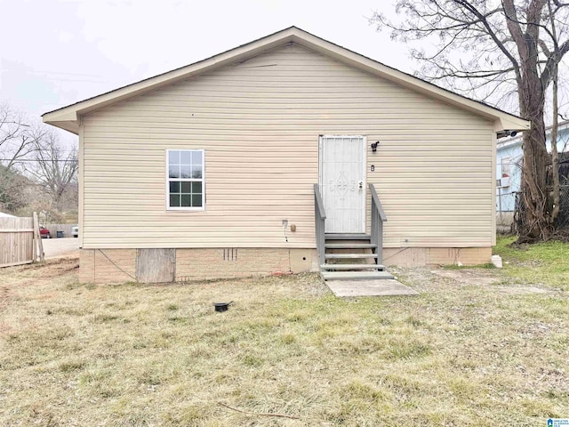 back of property featuring a yard