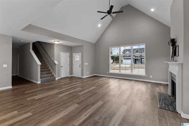 unfurnished living room featuring ceiling fan, dark hardwood / wood-style floors, and high vaulted ceiling