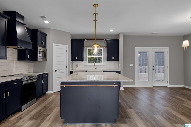 kitchen with hanging light fixtures, stainless steel appliances, a center island, dark hardwood / wood-style flooring, and custom exhaust hood