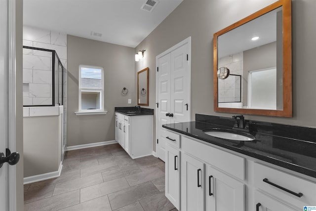 bathroom featuring vanity and a tile shower