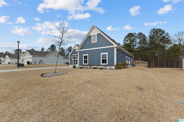 view of front of home featuring board and batten siding and a front yard