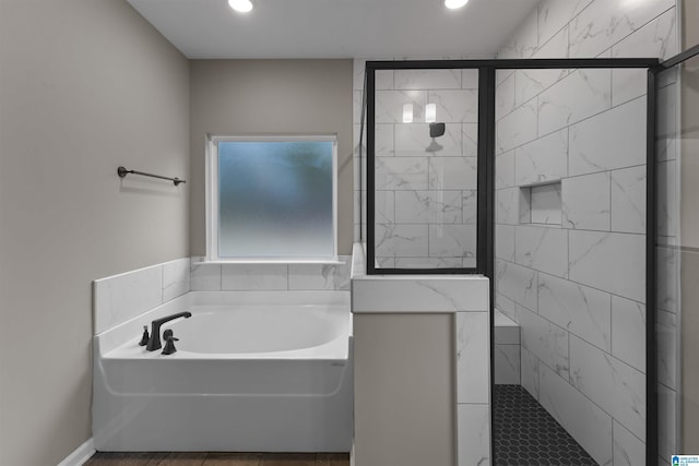 bathroom with separate shower and tub