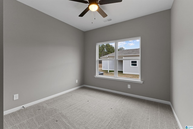 carpeted spare room with ceiling fan