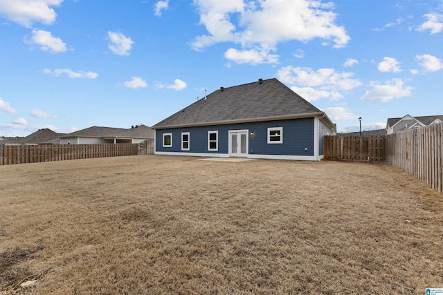 back of property featuring a yard