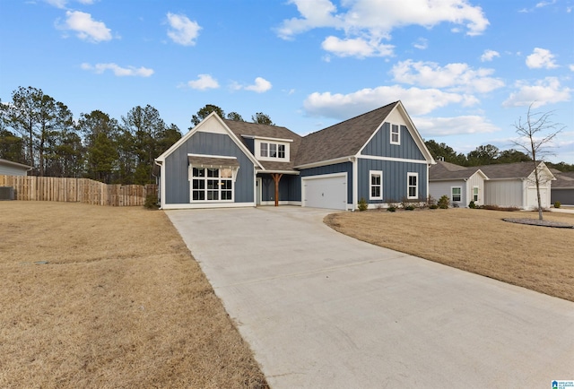 view of front of home featuring cooling unit, a garage, and a front lawn